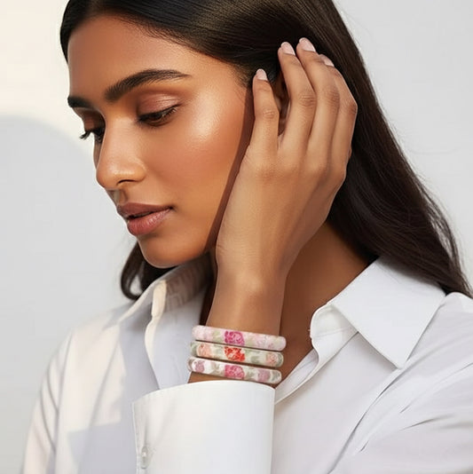 Woman wearing colorful bracelets on a plain background