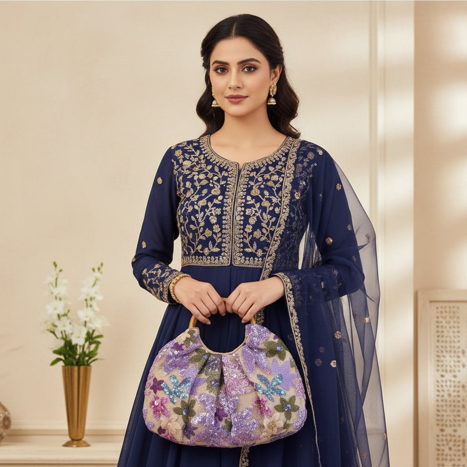 Person holding a floral sequin handbag indoors
