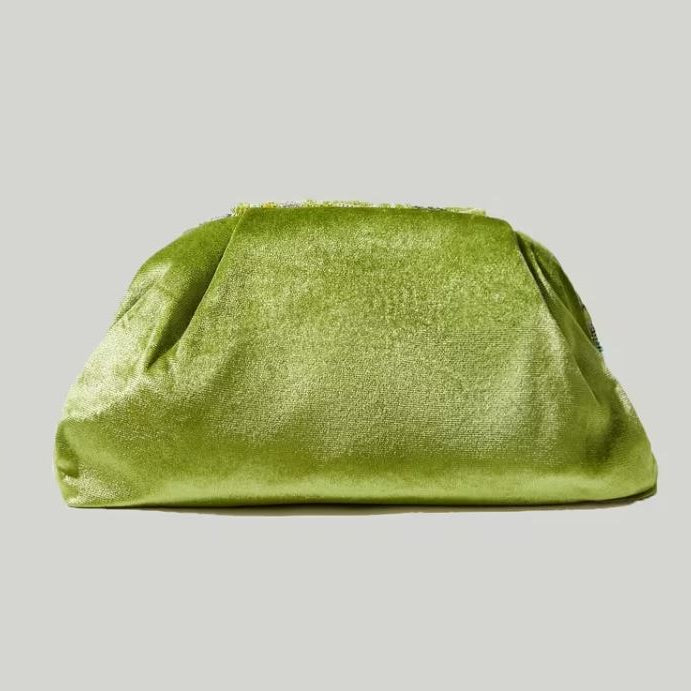 Green clutch bag on a light gray background