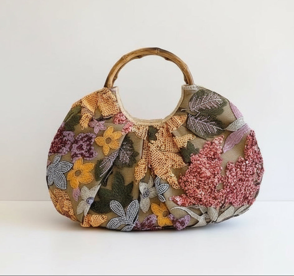 Floral patterned handbag with wooden handle on a white background