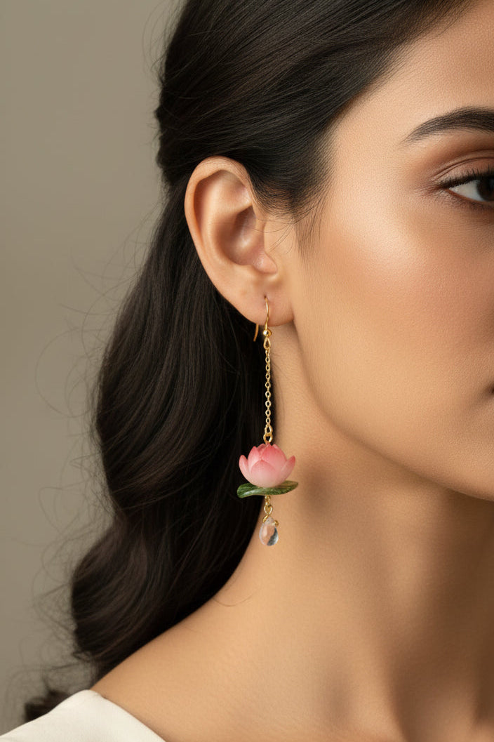 Pink flower earrings with gold chains on a white background