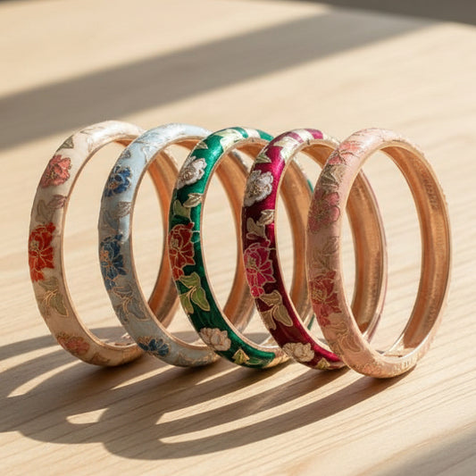 Set of floral-patterned bangles in various colors on a white background